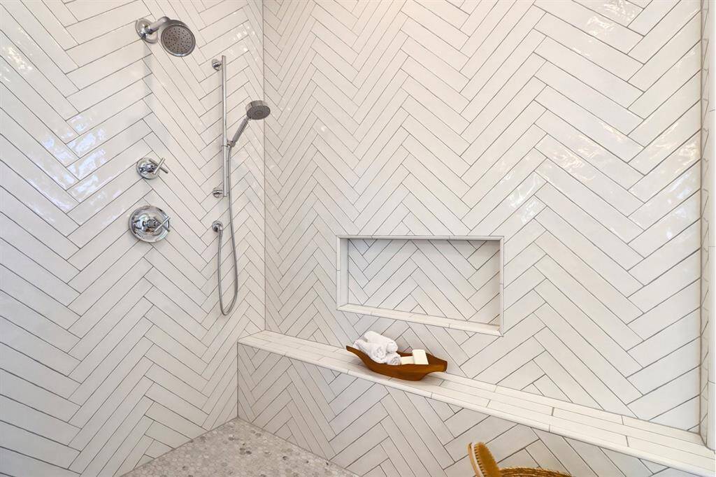 The walk in shower up close - marble hex flooring in the shower works with the main bathroom flooring perfectly and the tile work on the walls is stylishly timeless.
