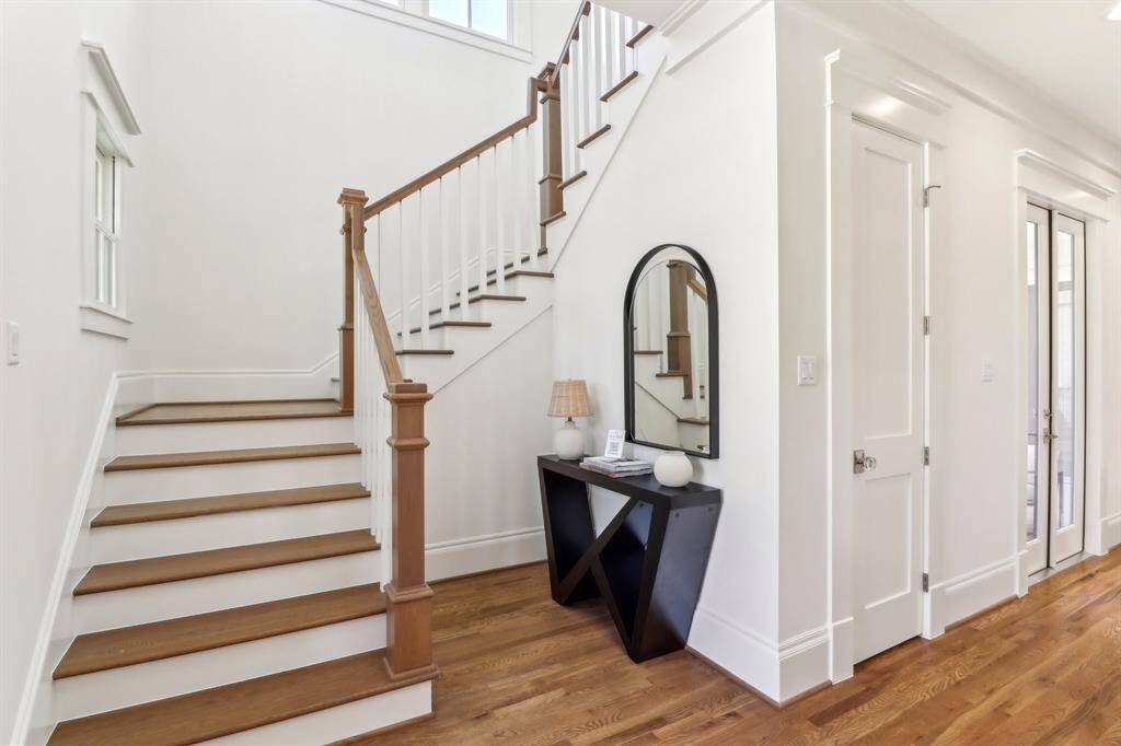 The main gallery in the home is true to a historical Craftsman two-story, with a stairway off to the side and a welcoming space in which to display a table with flowers, bench or a piece of art.