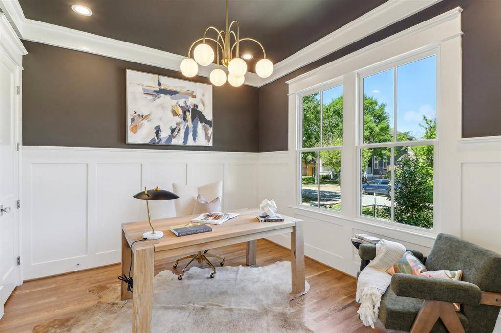 Panel molding and this sexy brass light fixture make this room-with-a-view a perfect space for your home office needs.