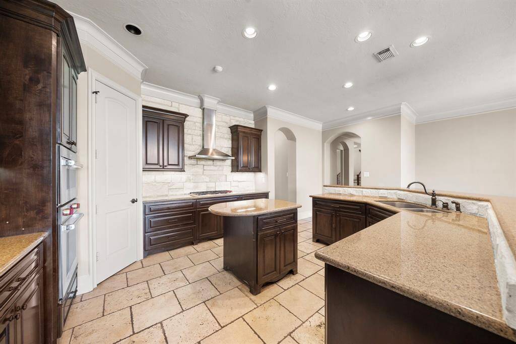 Custom kitchen with tons of cabinets, updated appliances included gas cooktop.