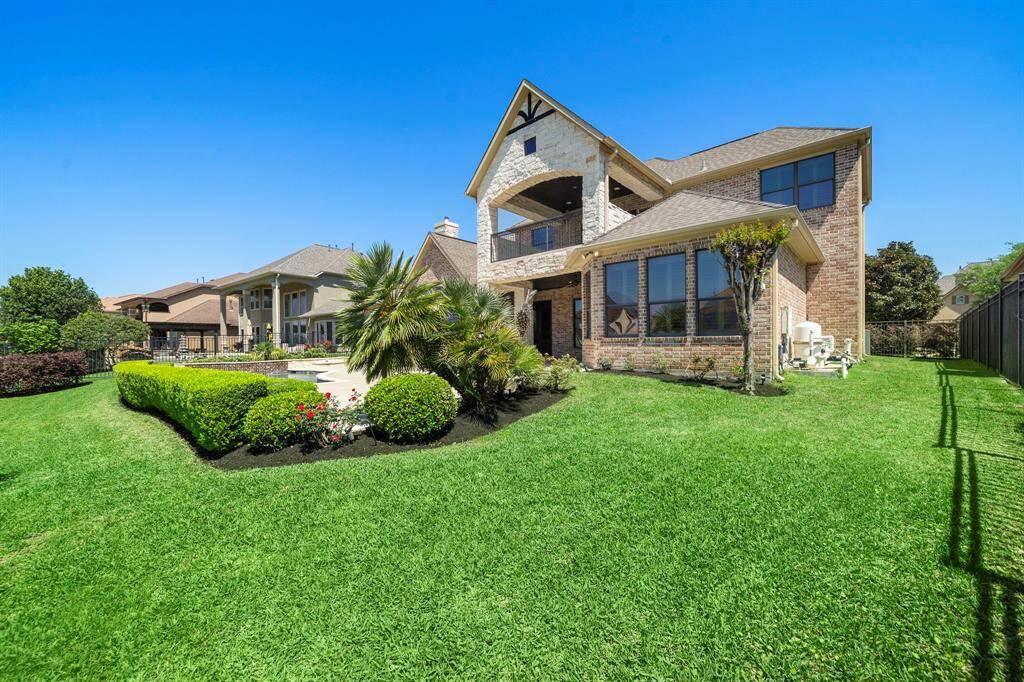 Covered Patio from living/kitchen. Views of water and pristine pool