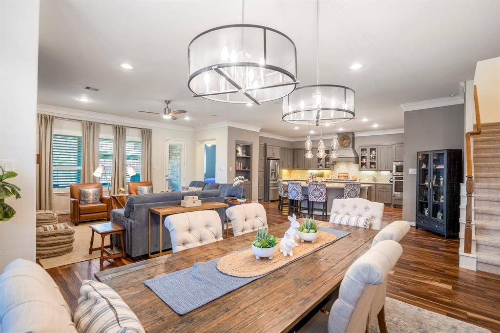 Beautiful dual lighting over the dining room table casts a soft glow on to the elegant dining space.