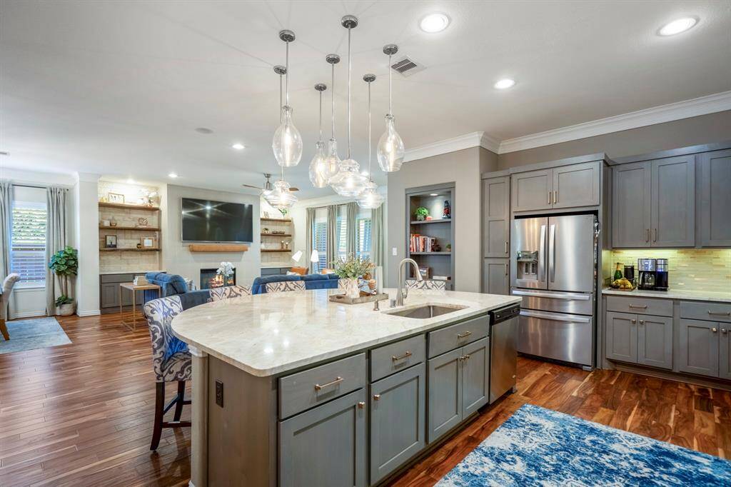 Neutral tones and beautiful hardware on the cabinetry elevate an already impressive island kitchen.