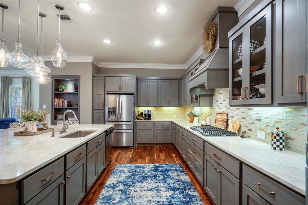 The tiled backsplash is enhanced with under mount lighting illuminate the countertops & backsplash.