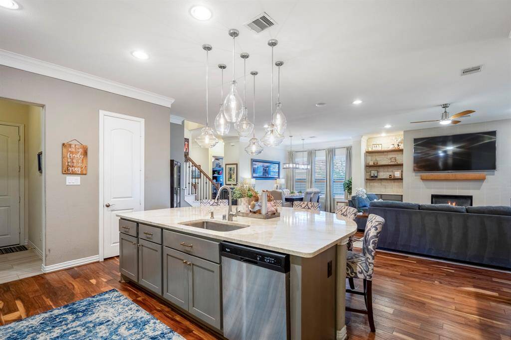 From floor to ceiling this kitchen and living area excels in style with light reflecting off the incredible floors.