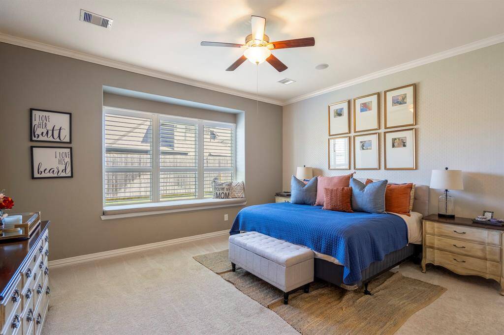 A spacious primary bedroom retreat with large insert window allows for morning sunlight.
