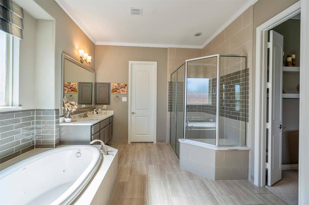 The primary bathroom features a large walk-in separate shower and dual closets.
