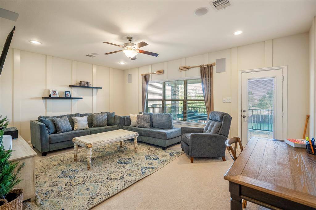 The gameroom offers tons of space to create multiple areas of relaxation with a glass door leading out onto the balcony.