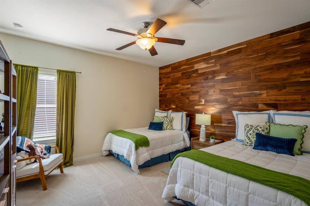 The second bedroom has a feature wood paneled wall which creates a real wow factor.