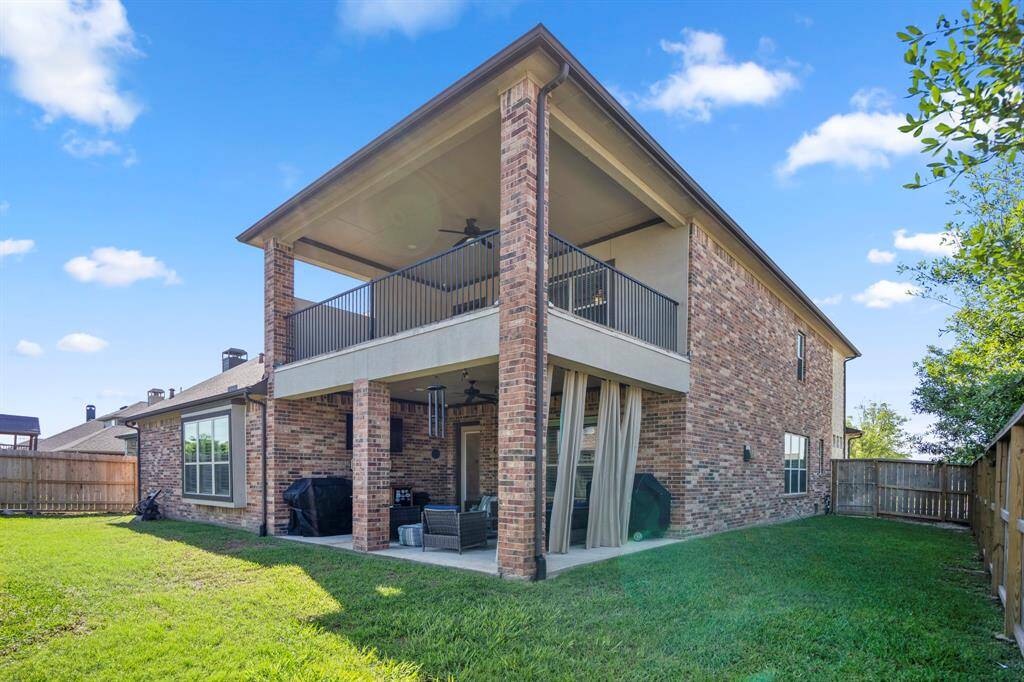 A view of the back of the home, with fully fenced backyard, where children and pets can play safely.