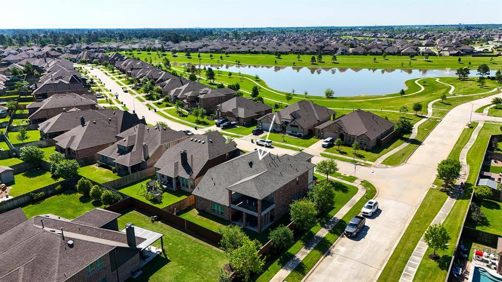 An aerial view of the home which shows there are plenty of walking trails that are close to the lake where you can exercise and enjoy the views.