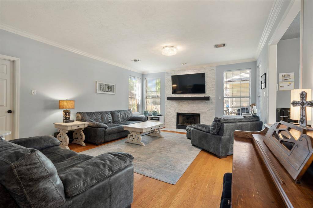 The Family Room is a cozy space with a gas log fireplace and beautiful wood floors.