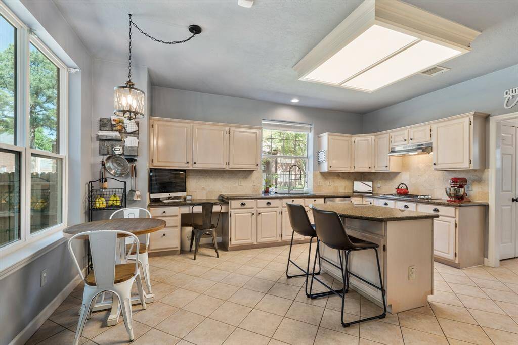 The well-designed Kitchen has plenty of counter space topped with granite and storage.