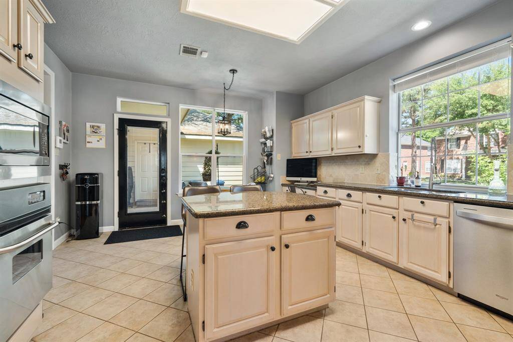 The picture window over the sink floods the Kitchen with natural light.