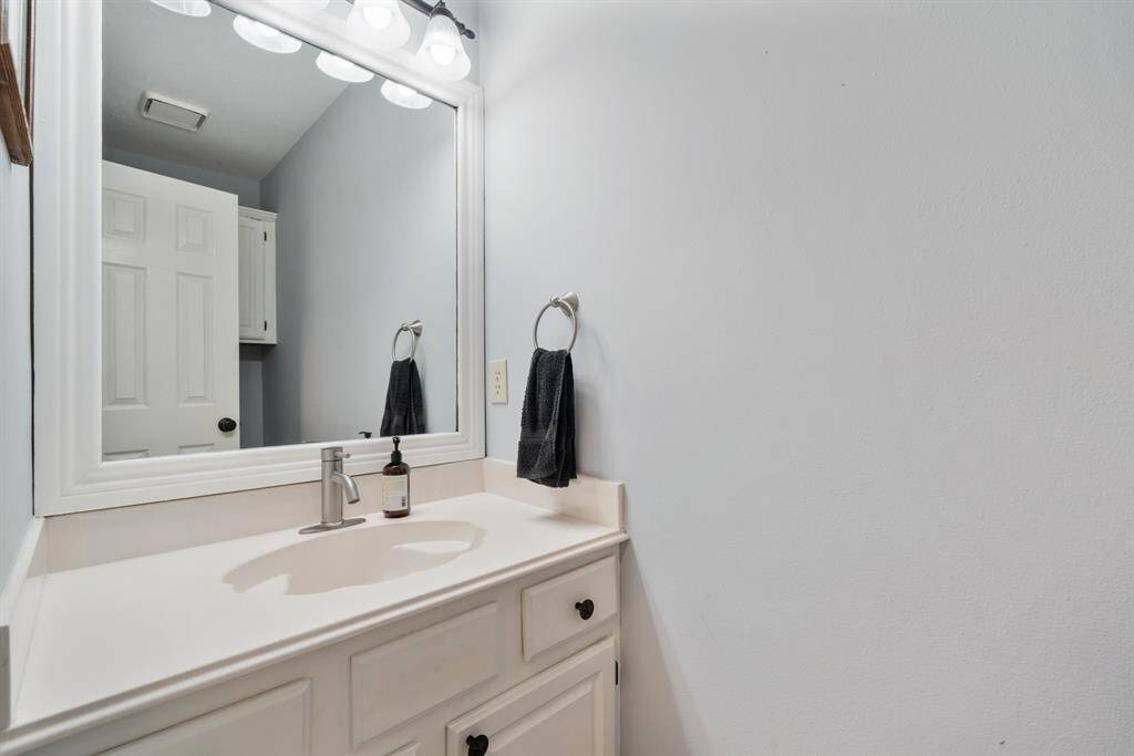 The half bath is between the Kitchen and the Dining Room.