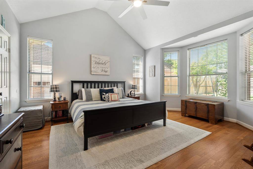 This primary Bedroom is just beautiful with its cathedral ceiling, bay window and continuation of wood flooring.