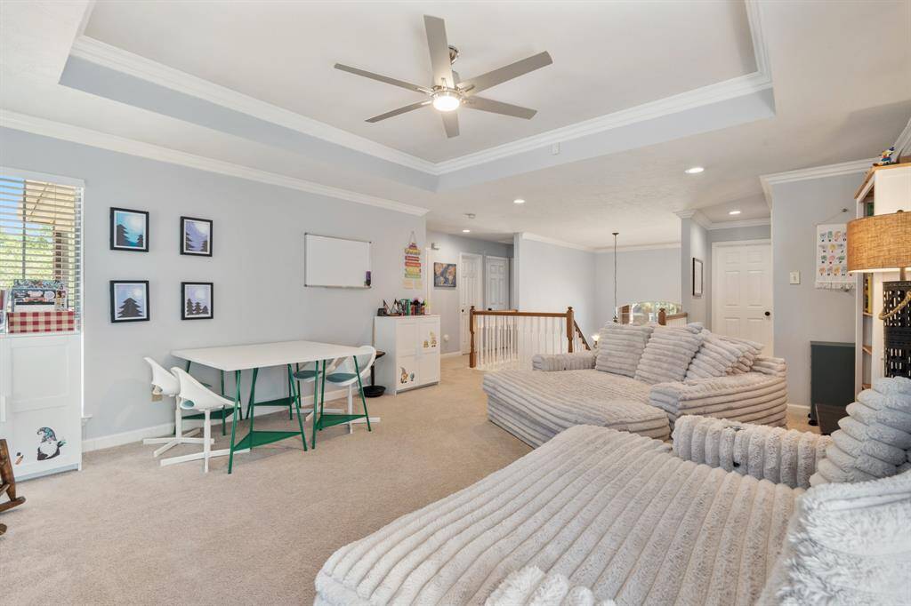 Fresh paint colors, the tray ceiling with ceiling fan and loads of natural light make this Game Room the place to be.