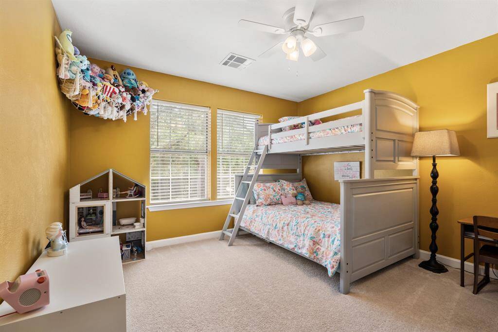 This secondary bedroom faces the front of the home and has a large walk in closet.