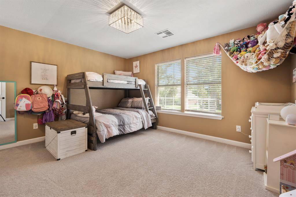 This secondary bedroom faces the front of the home and is very spacious. It also features a walk in closet.