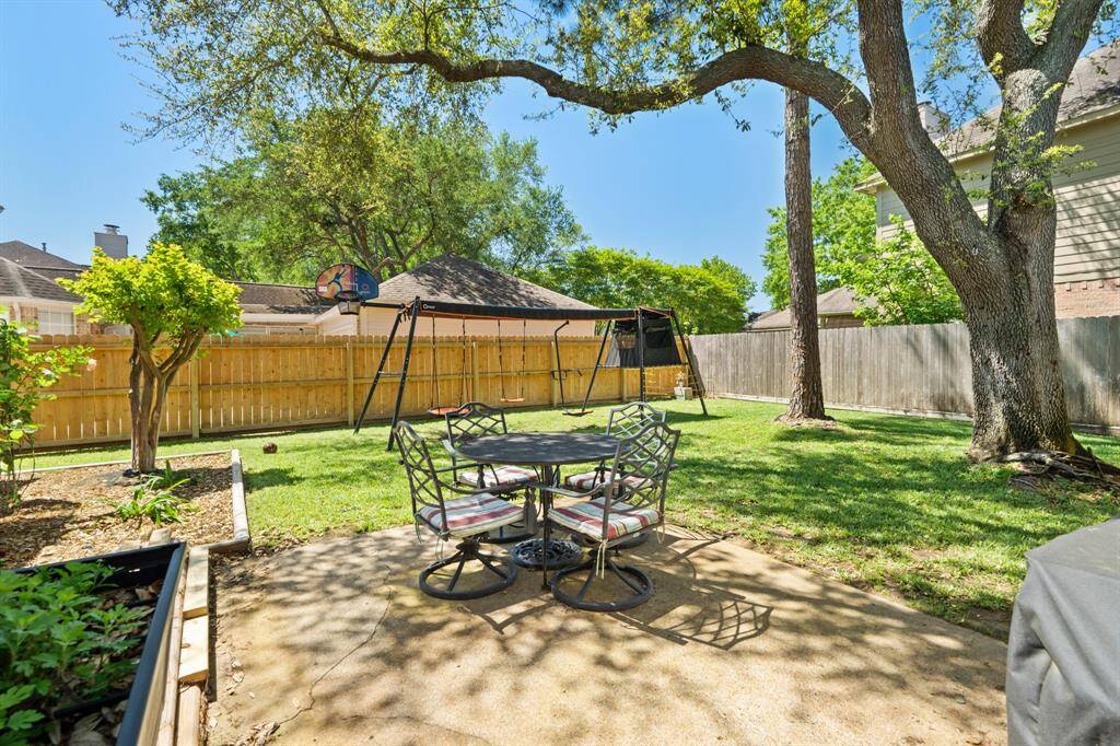 The backyard has a great patio area as well as plenty of yard space to play! The nice tree provides the perfect shade for those hot summer days.