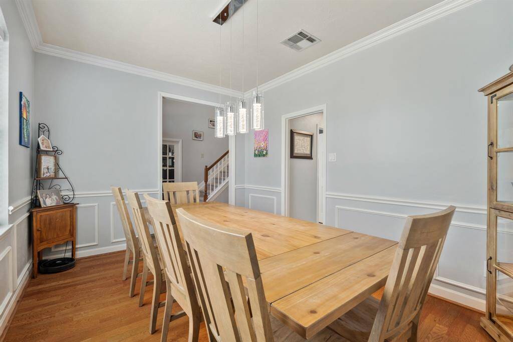 To the right of the Entry is the pretty Dining Room with chair railing, large windows and updated lighting.