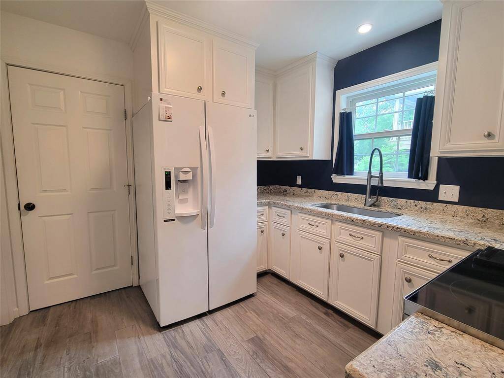 Wood look tile is throughout the kitchen, breakfast room, and foyer.