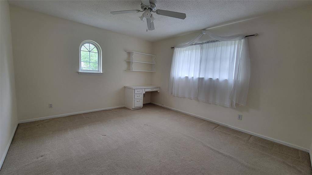 Bedroom 2 with built-in desk, lots of natural light, and a walk-in closet!