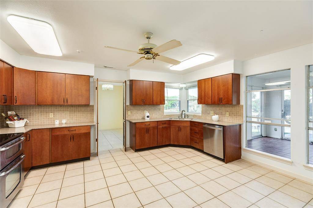Kitchen with tiled back splash, granite counters and stainless appliances.