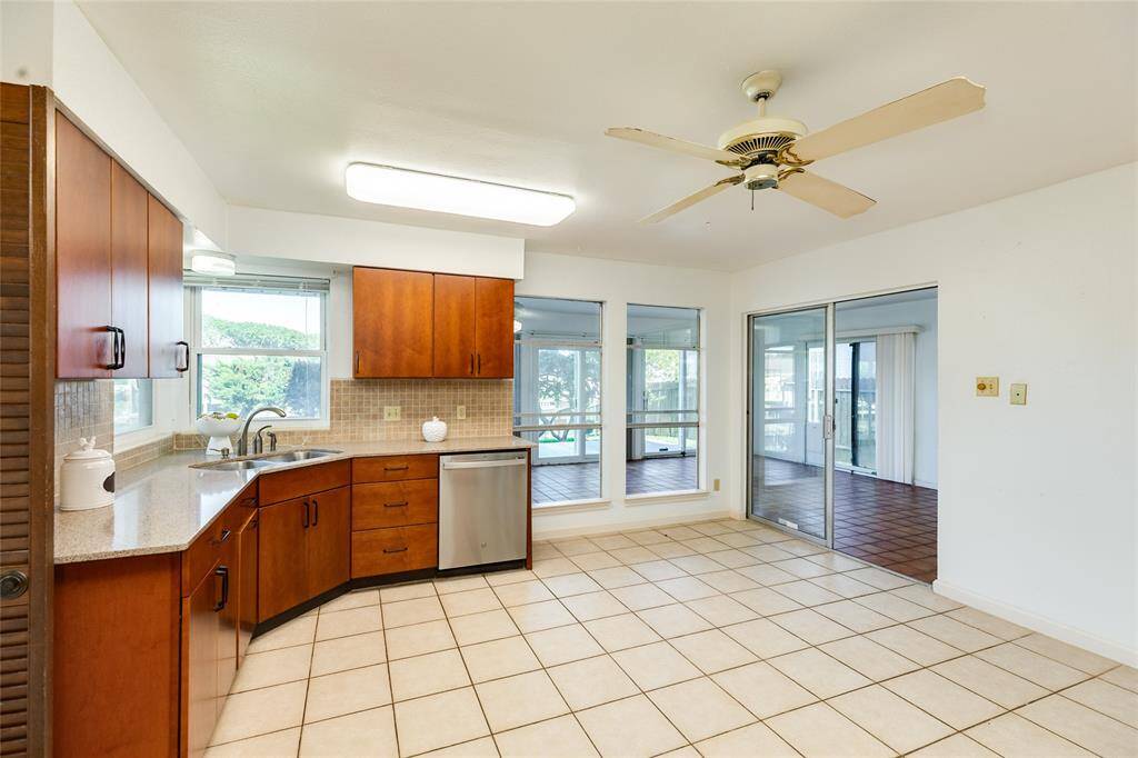 Kitchen leading to the enclosed sun room.
