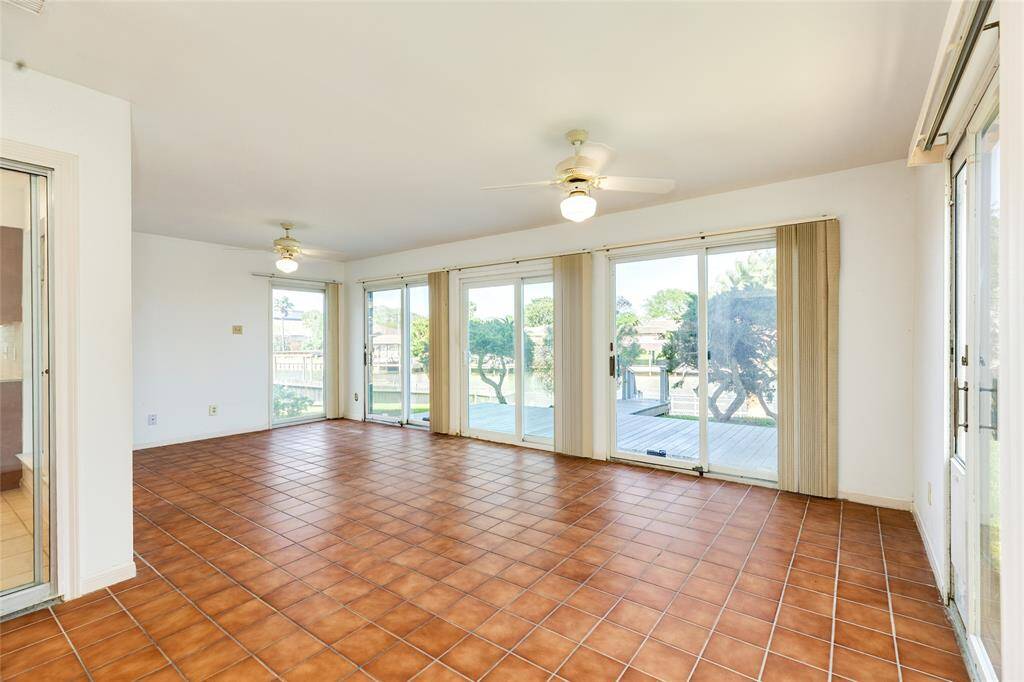 Sun room with wall to wall windows for enjoying waterfront views.