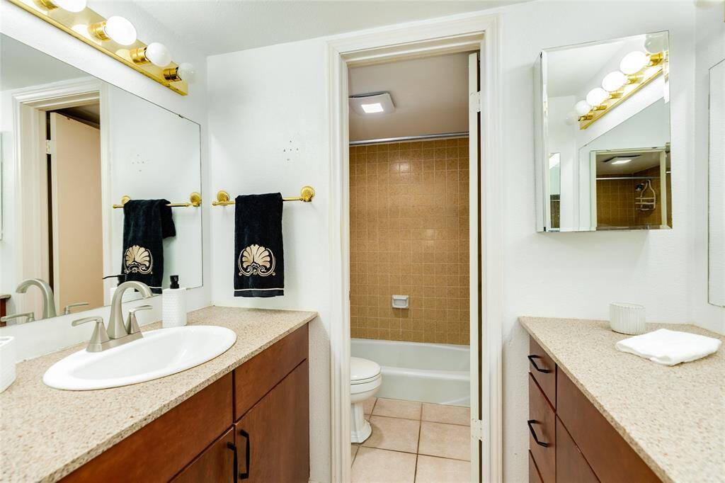 First level bathroom with vanity area, tub and shower.