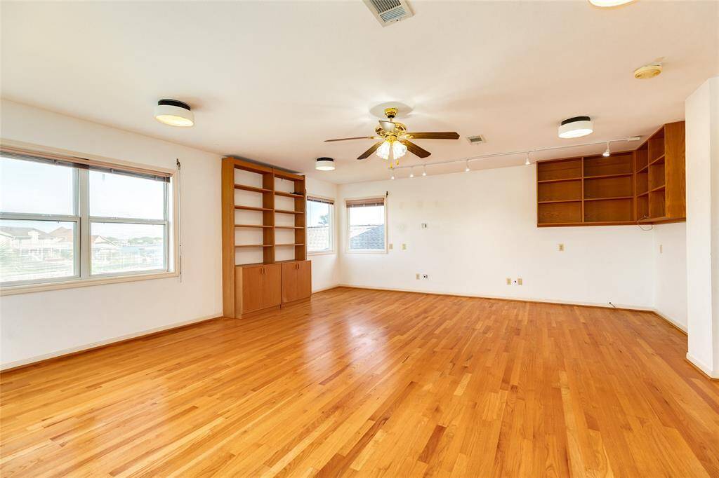 Large 2nd floor room that could be den, study, family room, game room and more.  Has wall to wall waterfront views.