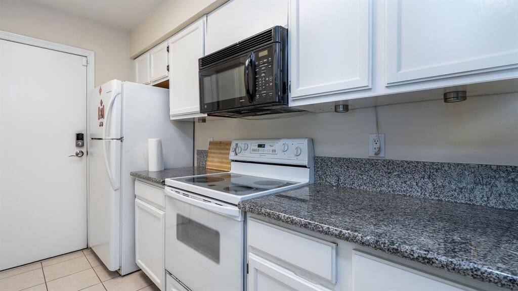 Electric stove, built-in microwave & refrigerator included.