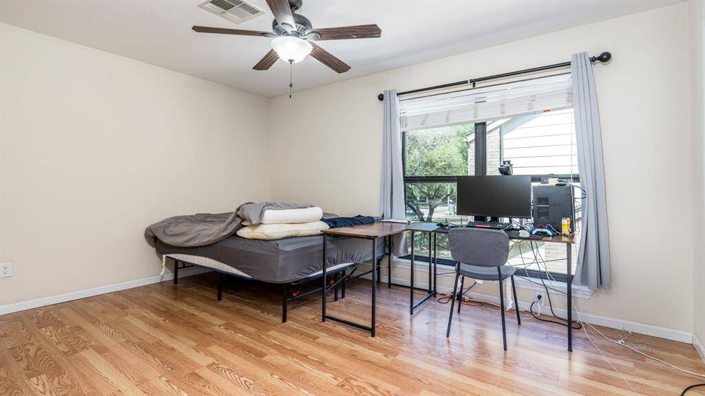 Bedroom #1 with laminate floors and ceiling fan.