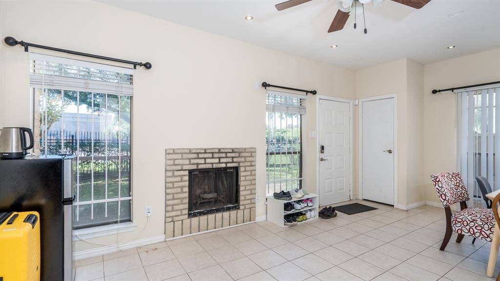 Living room features a gas log fireplace and ceiling fan.