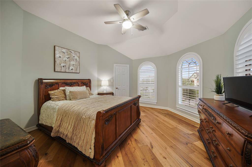 Beautiful Guest Room with Arched Windows & plantation Shutters & Wood Flooring