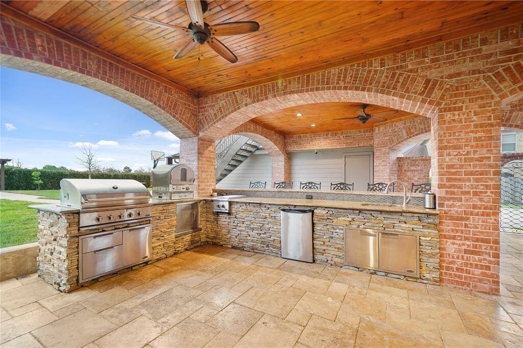 Beautiful Brick and Stone Outdoor Kitchen, Grill, Pizza Oven, 2 Gas Burners, Sink, Beverage Fridge and Storage!