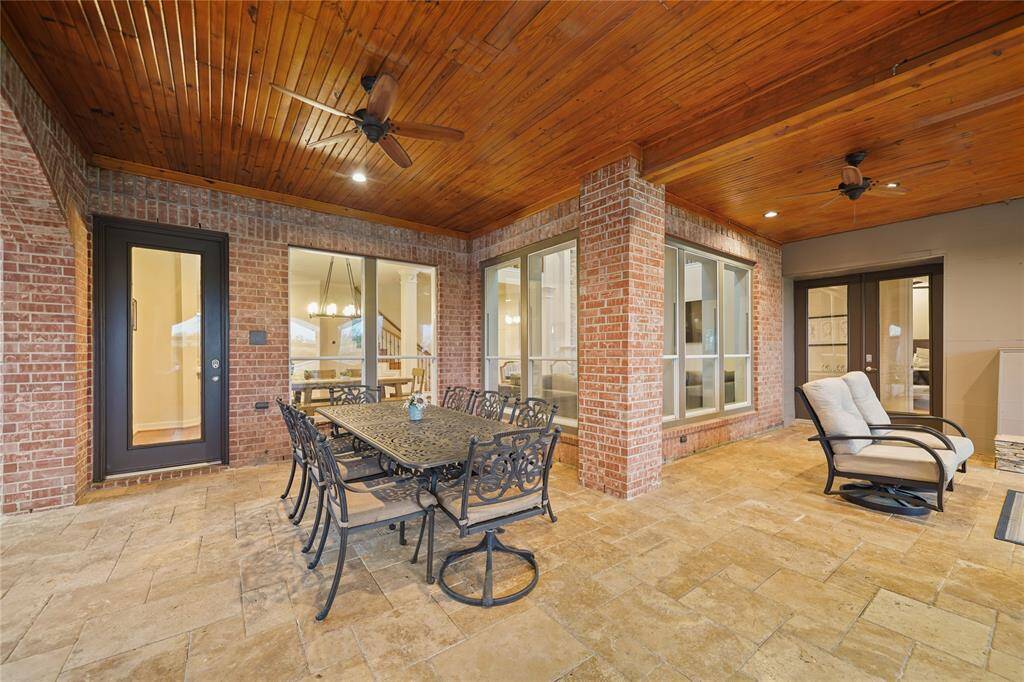 Beautiful Outdoor Dining Area, Travertine Flooring & wood plank ceilings