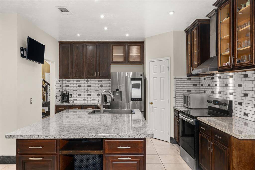 Modern meets function in this sleek kitchen featuring granite countertops, stainless steel appliances, and a spacious island perfect for cooking or entertaining.