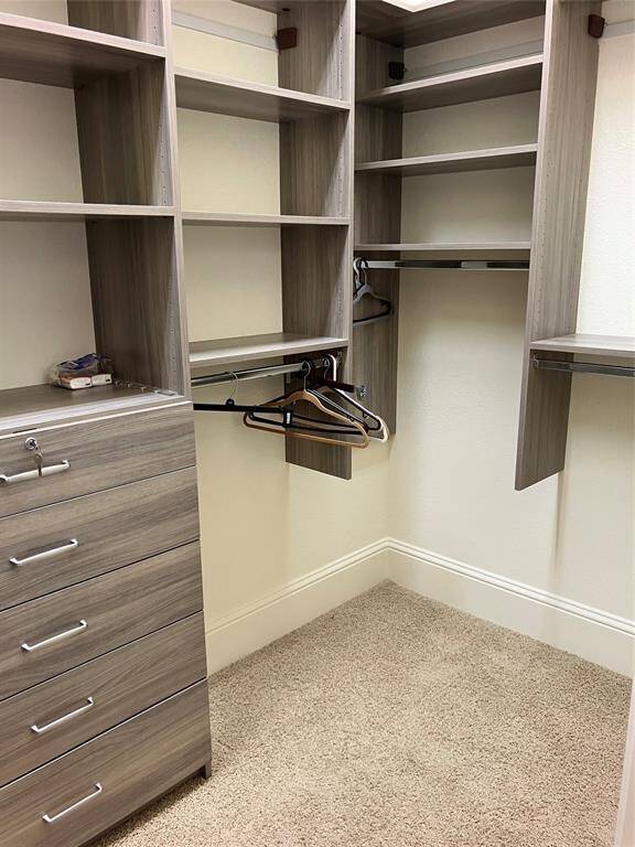 Exceptional primary closet with built-ins all around, even a lockable jewelry drawer; this is only half of it.