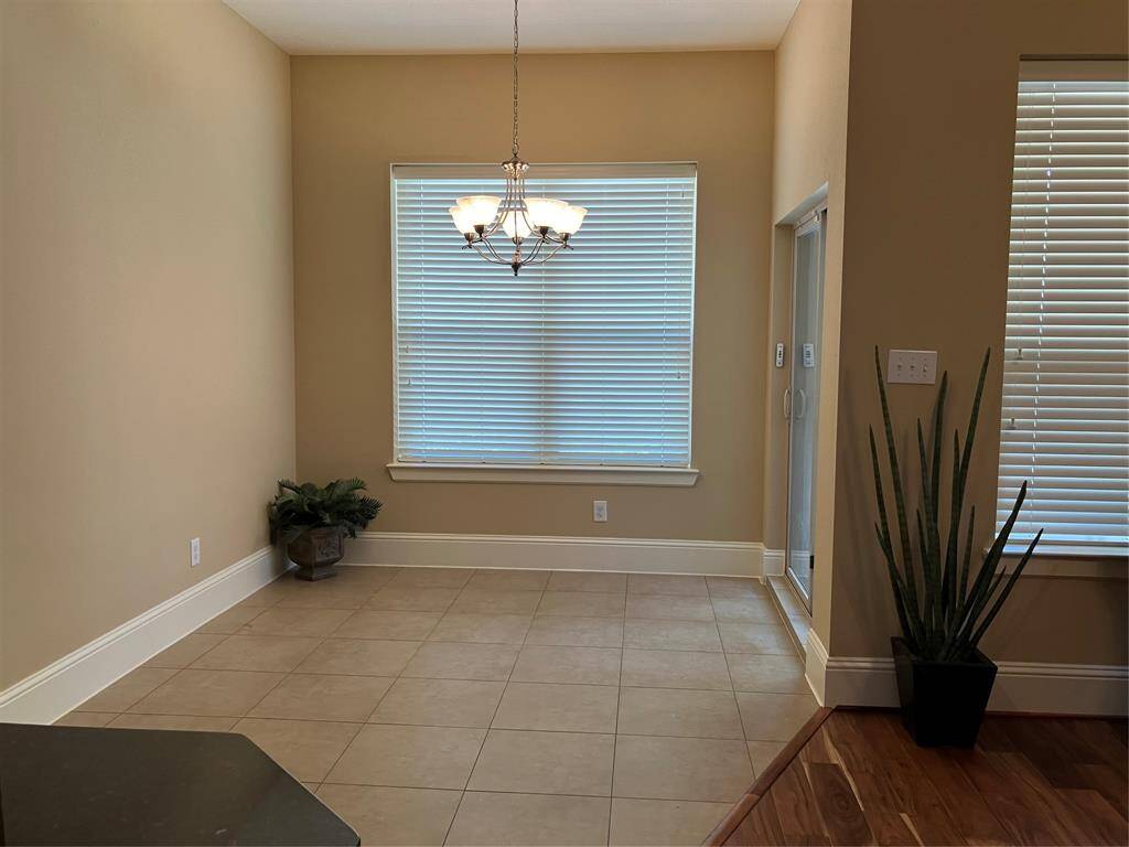 Breakfast room off the kitchen, sliders out to covered porch and giant patio
