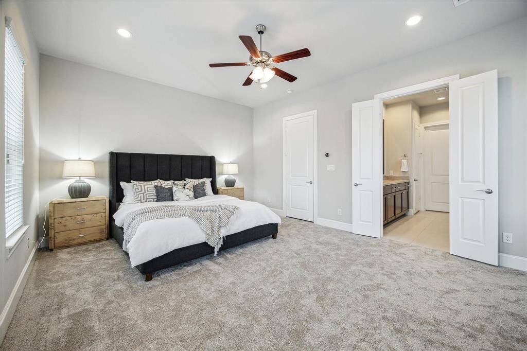 Large primary bedroom with fresh carpet and extra windows, providing an abundance of natural light