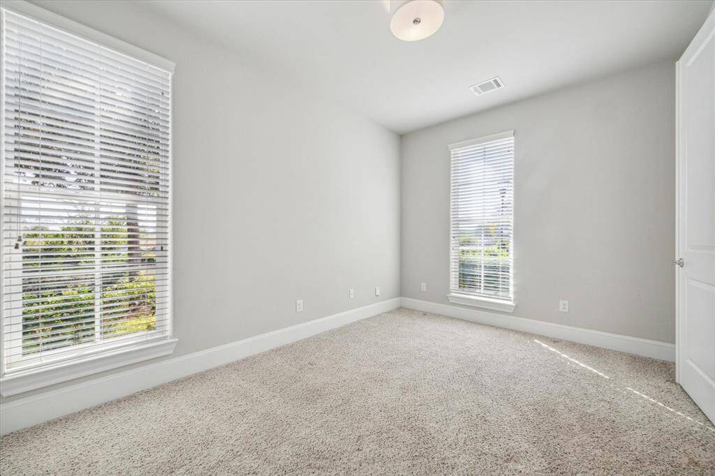 Spare bedroom with fresh carpet on the 1st floor, also the perfect space for an in-home office off the entrance of the home