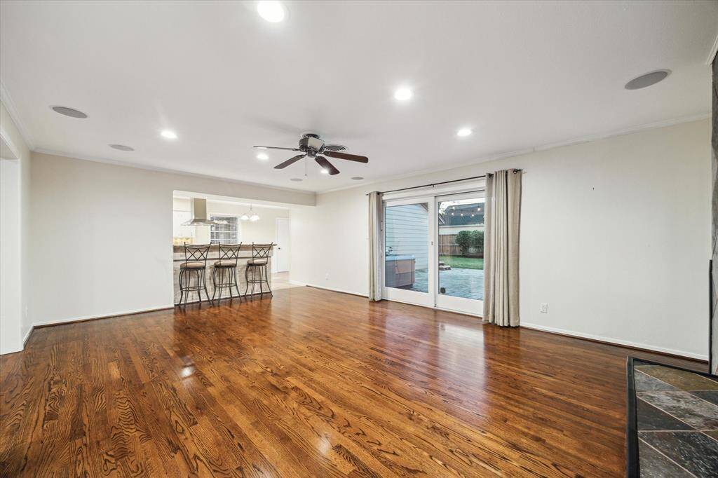 Large family room with beautiful hardwood floors.