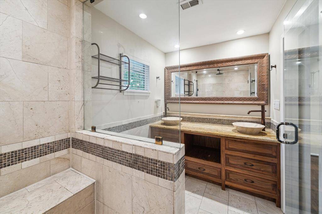 Double sinks with granite countertops and custom mirror. Braun silent fan 2020.