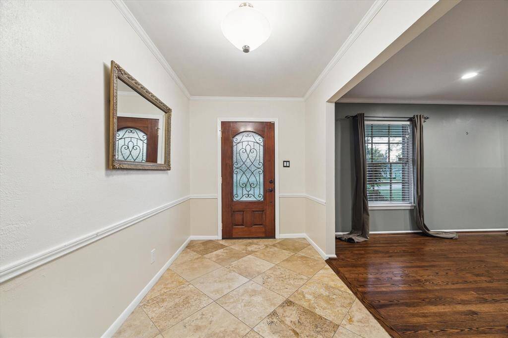 Solid wood door with wrought iron insert, burgler resistant, reinforced hinges and locks. Hardened/kick resistant front door.