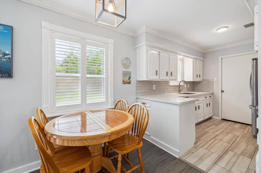 Enjoy casual meals in this cozy breakfast nook, with backyard views and easy access to the kitchen.