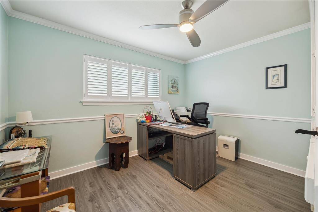 One of three spacious bedrooms, this flexible space is ideal as a home office, study, or guest room.
