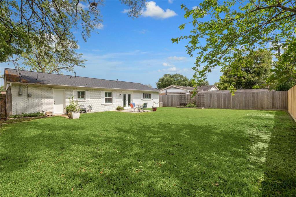 Another angle of the spacious backyard shows off the patio and potential for your dream outdoor retreat.