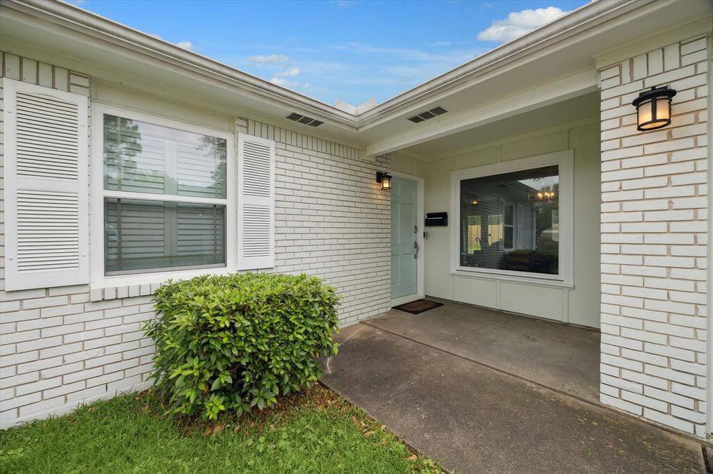 The cozy covered front porch sets the tone for relaxed living, with modern lighting and a welcoming entry.